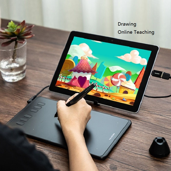 Hand using drawing tablet, cartoon on screen. Text: Drawing Online Teaching.