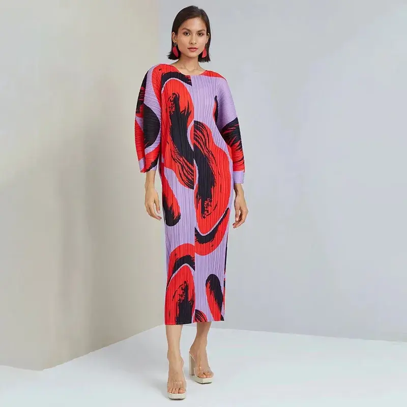 Woman in purple, red, black abstract print pleated dress