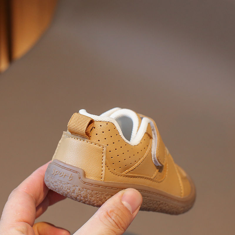 Thumbnail: Baby's tan shoe held in hand