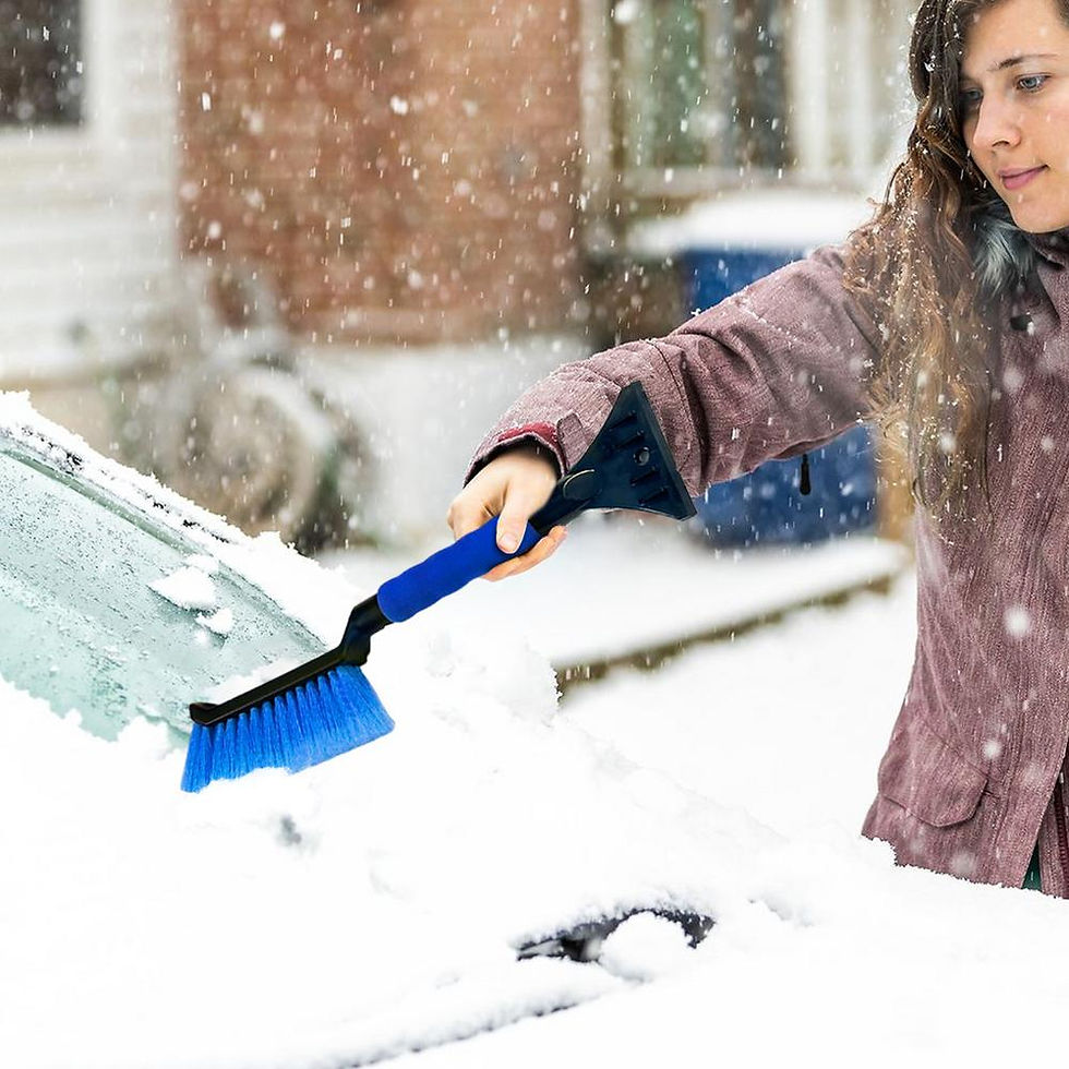 Thumbnail: Woman clearing snow from car windshield with blue brush