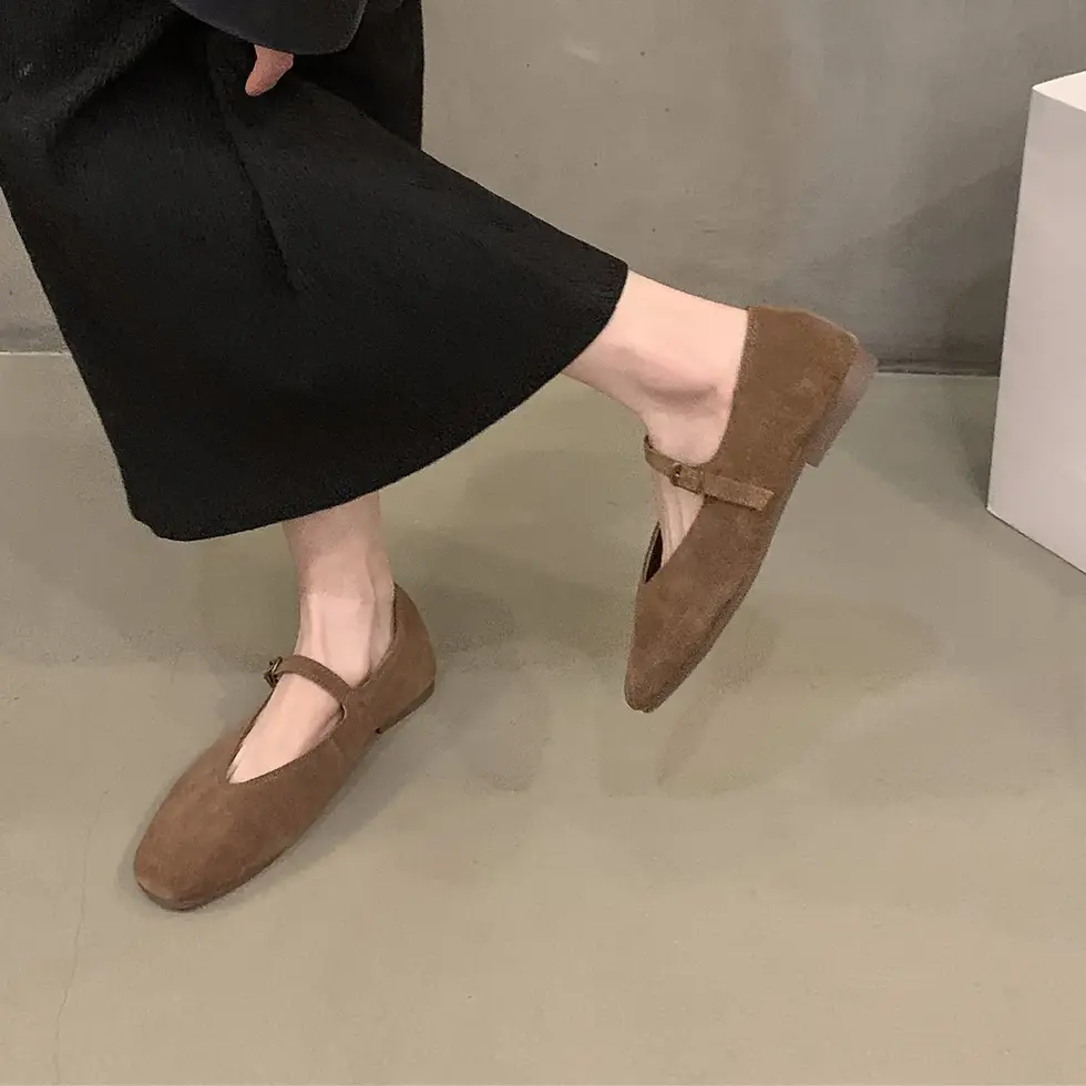 Thumbnail: Woman wearing brown Mary Jane flats