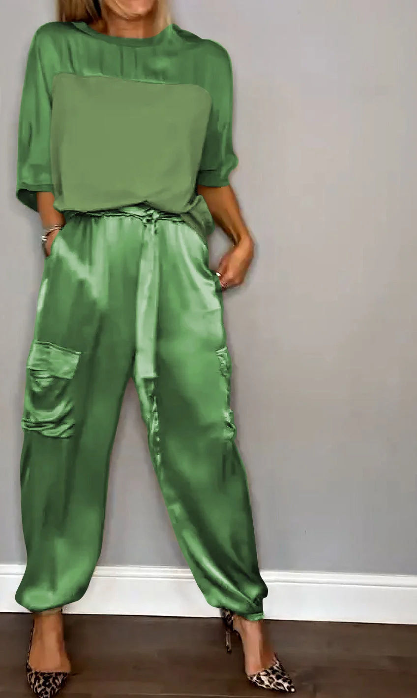 Thumbnail: Person wearing green satin cargo pants and matching top