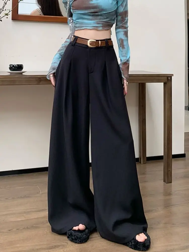 Thumbnail: Black wide-leg pants with a brown belt