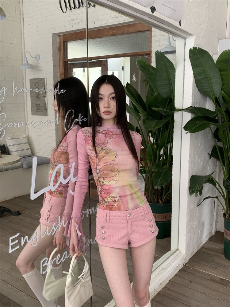 Thumbnail: Woman in pink floral long-sleeve top and pink shorts