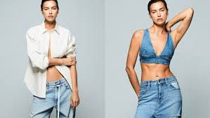Thumbnail: Woman modeling light wash denim jeans with two tops