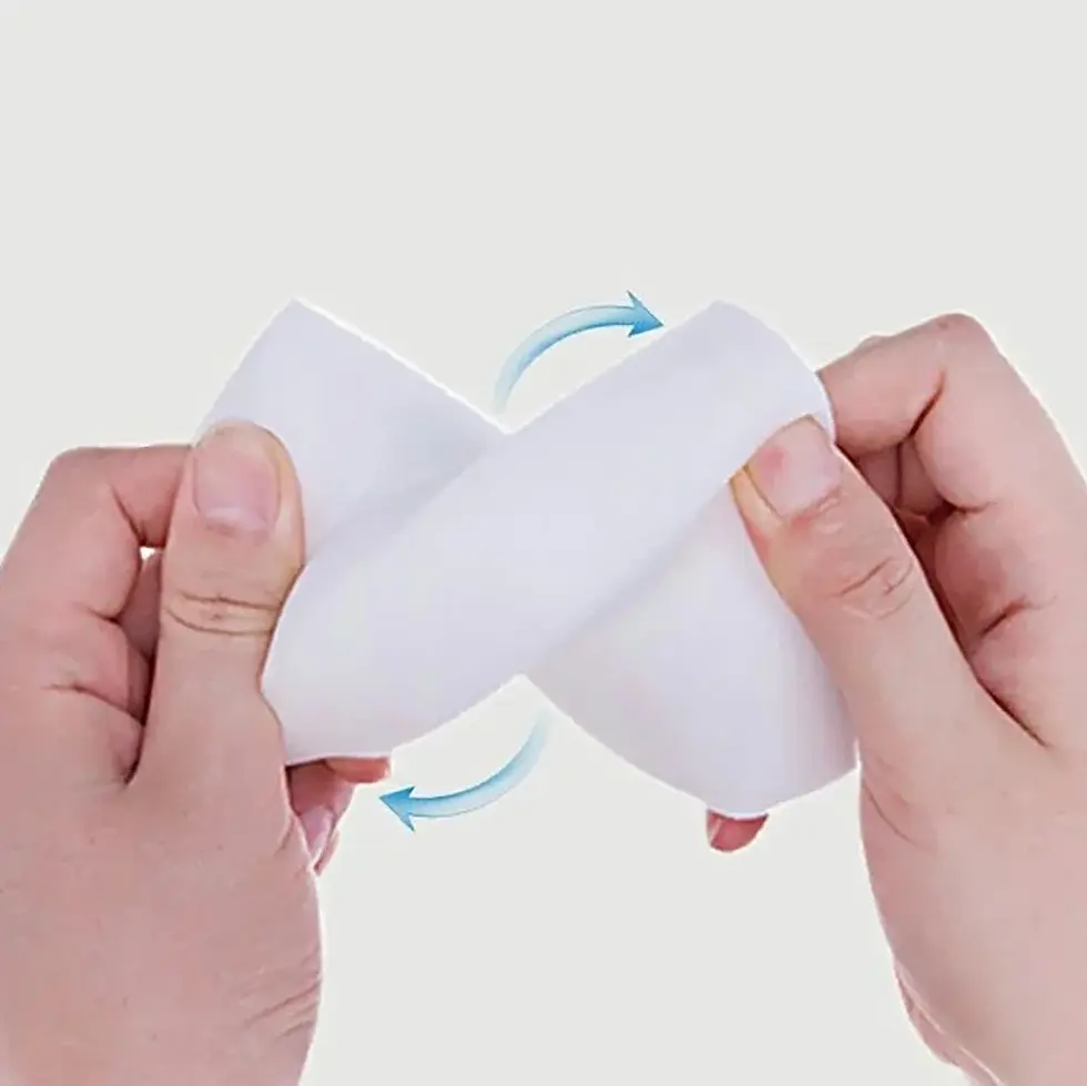 Thumbnail: Flexible white cleaning brush squeezed by hands