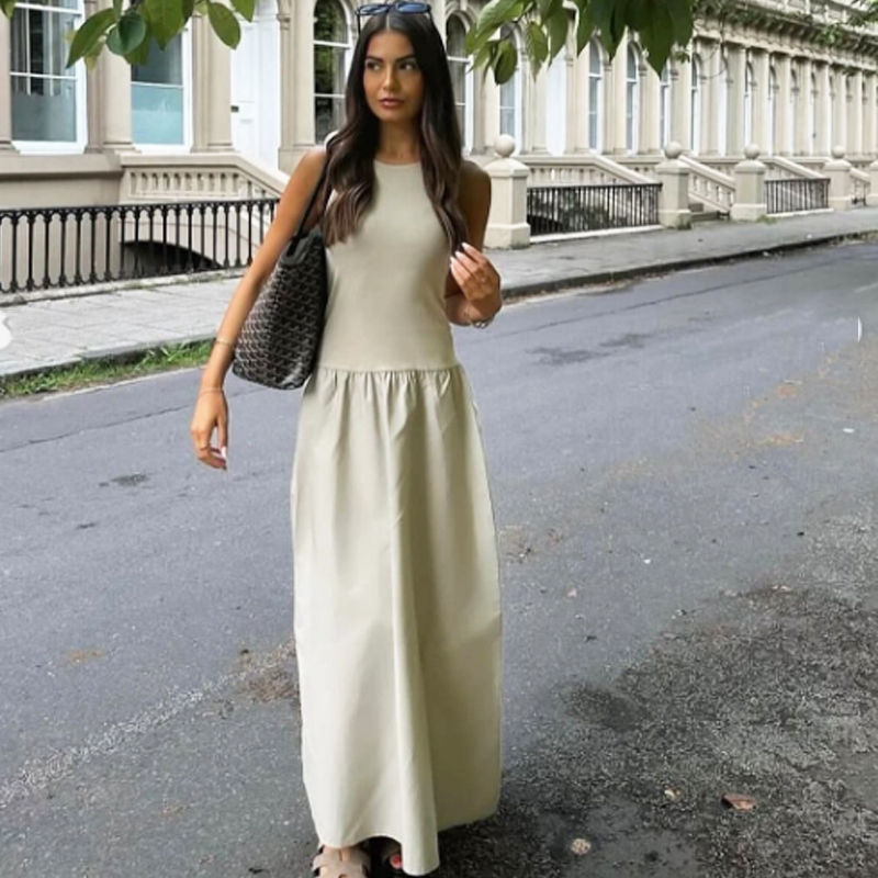 Thumbnail: Woman in light long dress walking on city street