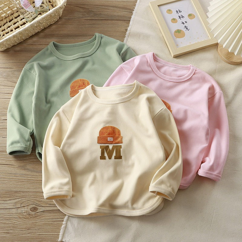 Thumbnail: Three long-sleeve kids' shirts; pink, green, and cream with 'M'