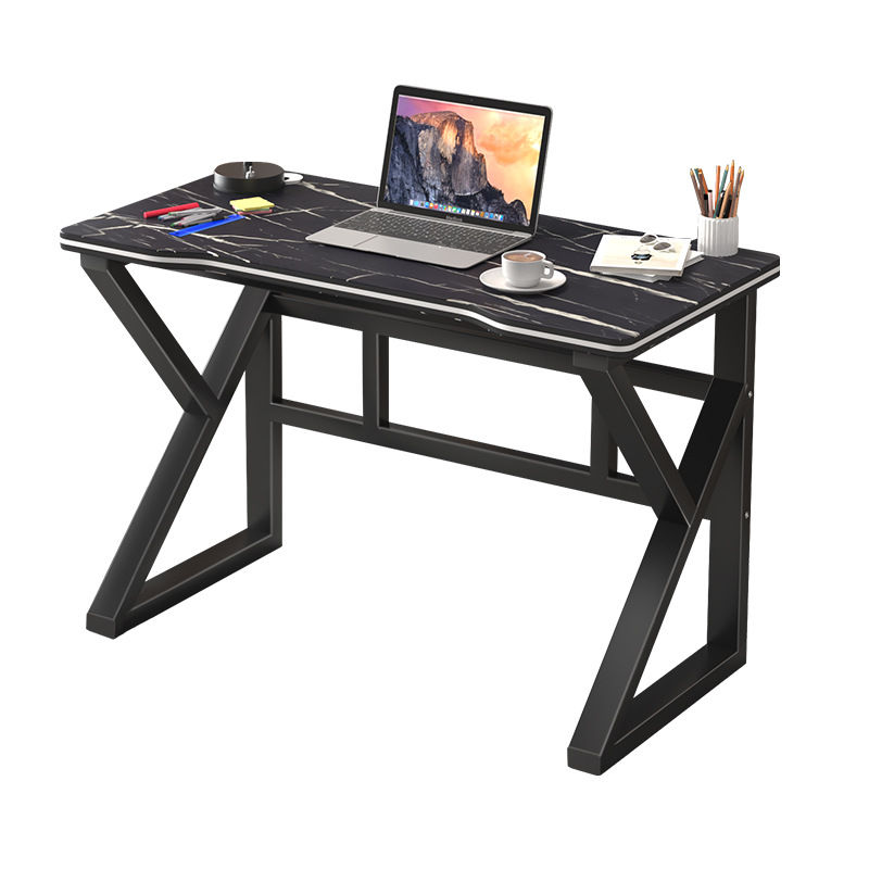 Modern black gaming desk with laptop and accessories.