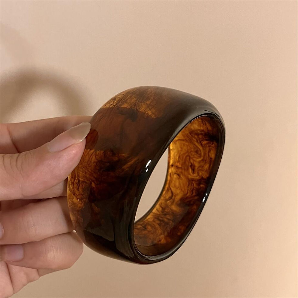 Thumbnail: Irregular chunky brown resin bangle in hand