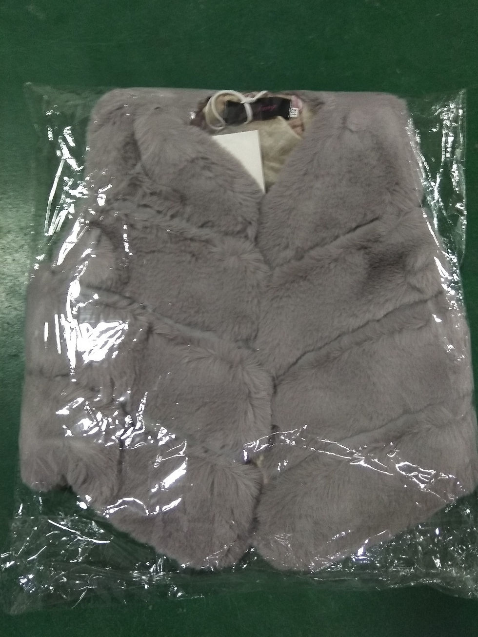 Thumbnail: Grey faux fur vest in plastic packaging