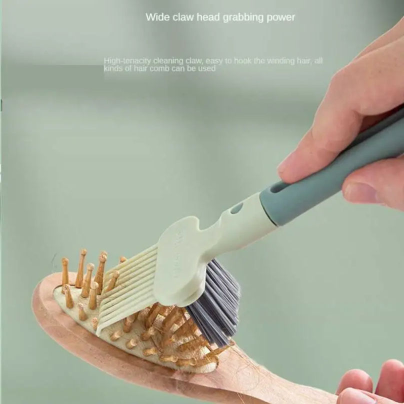 Comb cleaning brush removing hair from a wooden hairbrush