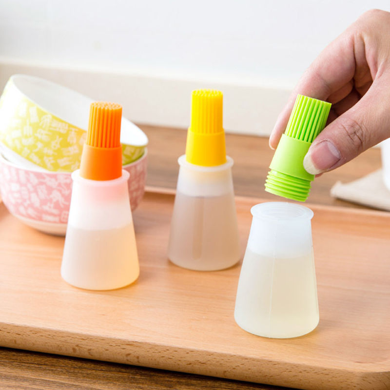 Thumbnail: Hand placing green silicone basting brush bottle