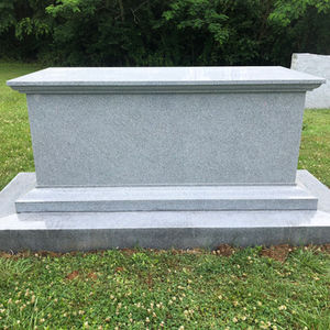Simple polished gray granite bench memorial with a stepped base, ready for custom engraving.