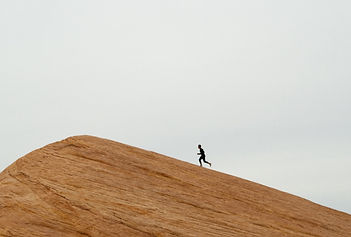man running up rock face
