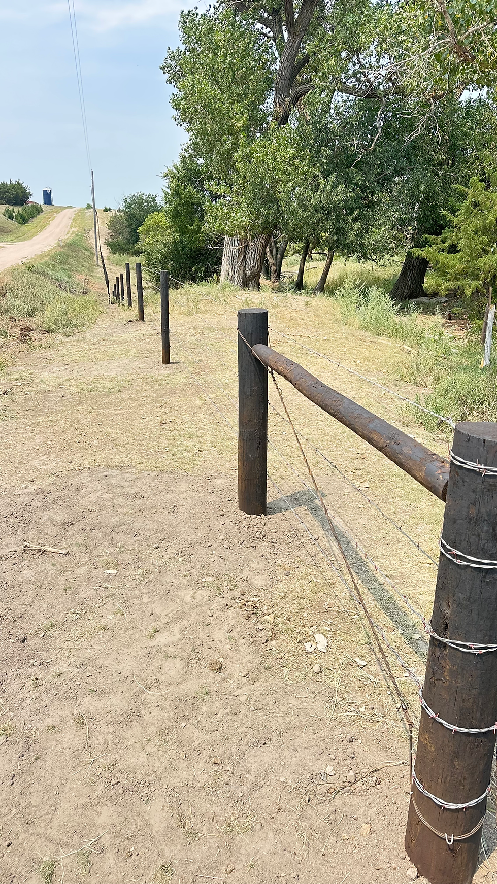Barbed wire fence corner and fence line
