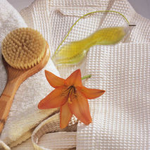 a spa robe, dry brush and eye mask for a home spa day.
