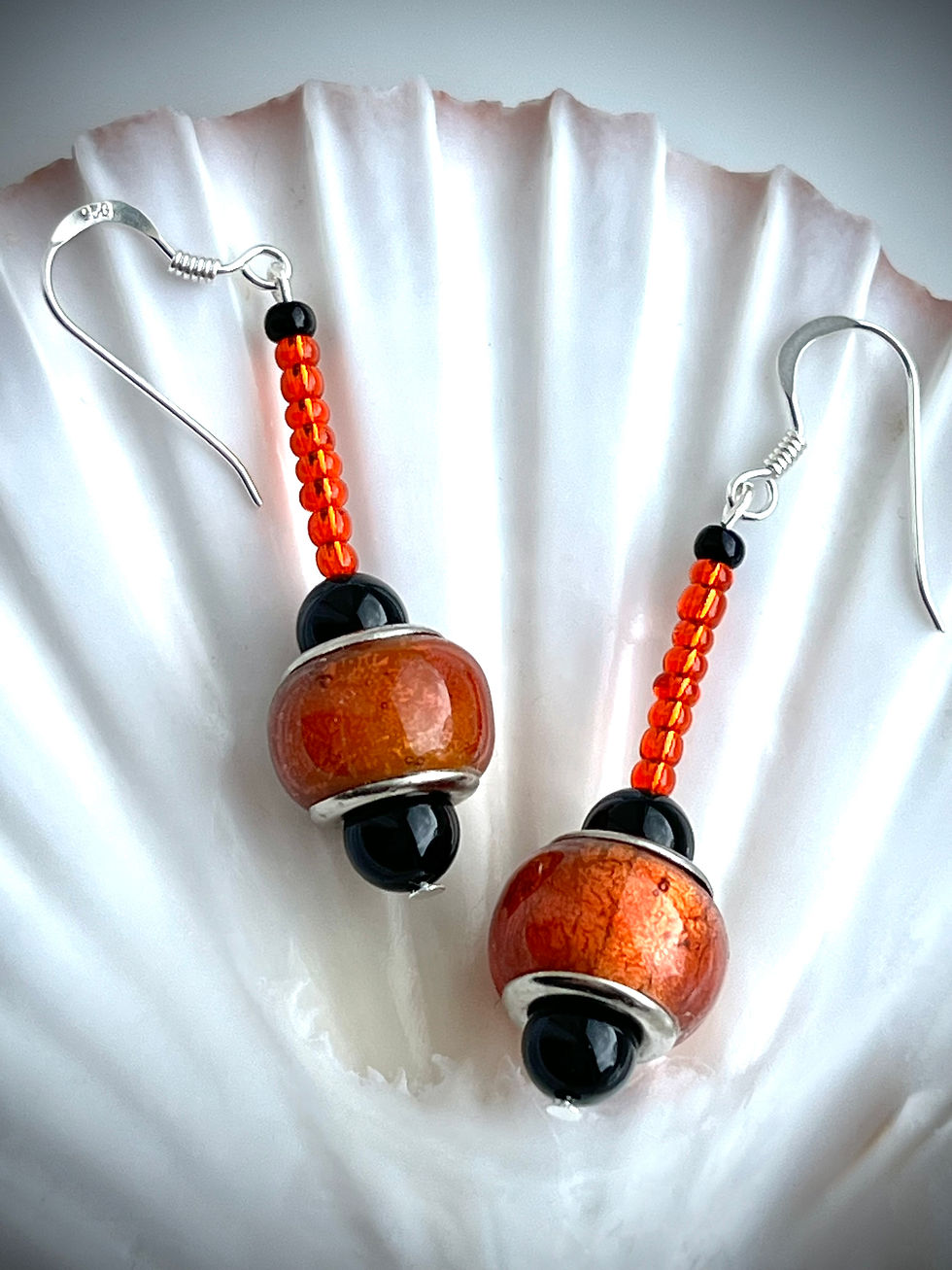 Thumbnail: orange and black glass bead earrings