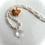 Thumbnail: Crystal cross necklace on pearl and crystal glass bead chain