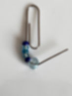Adding glass beads to a paper clip