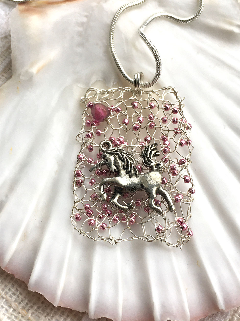 Knitted wire and glass bead with silver Unicorn charm  pendant