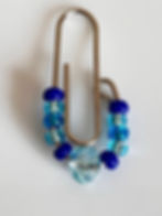 Glass beads threaded onto paper clip