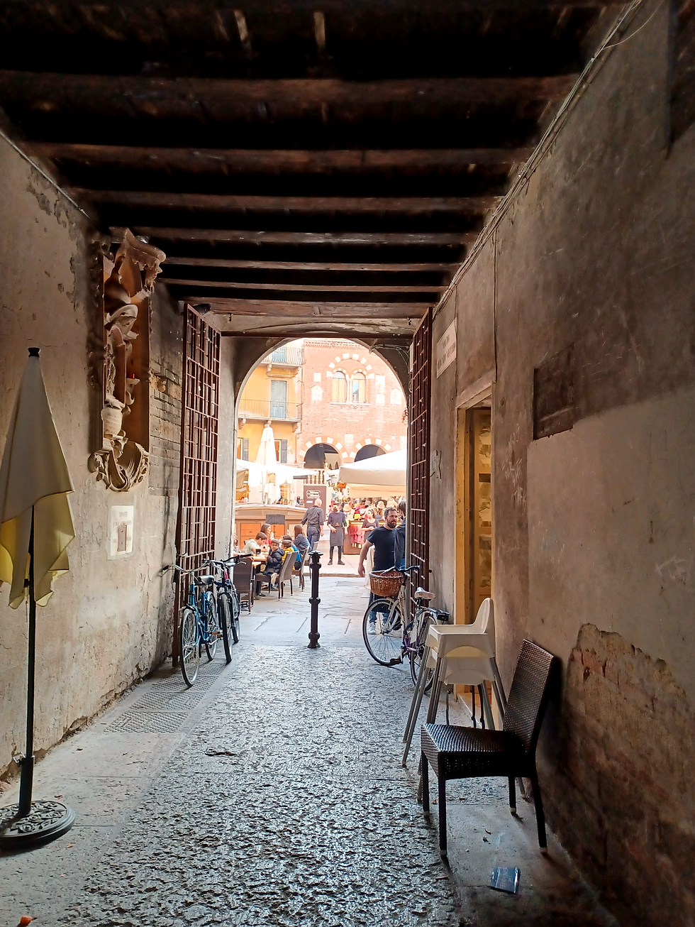 Verona's alleyways connect the piazze with wooden beams, bicycles and sculptures