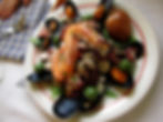 Seafood with prawns, clams, olives and octopus on an Italian plate.