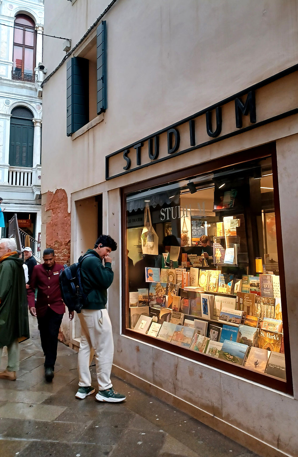 Studium Bookshop in Venice with young man looking at the books in the window