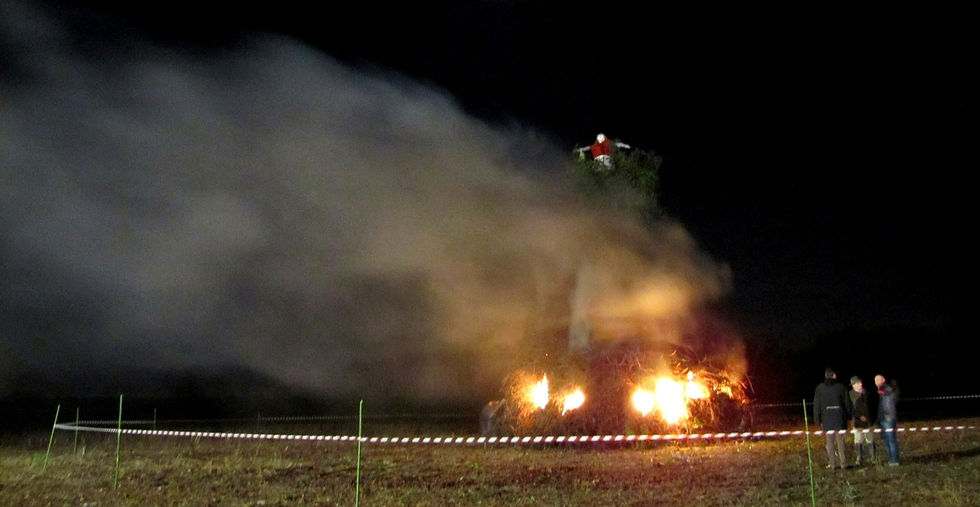 Smoke billowing from a bon fire with a guy on top for panevin.