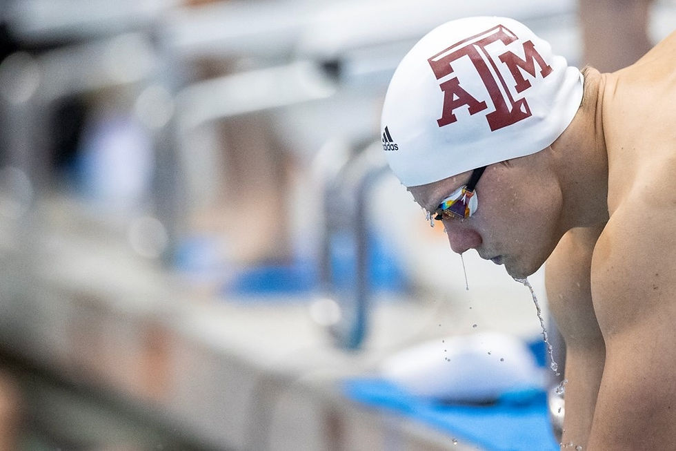A swimmer in deep focus preparing for competition