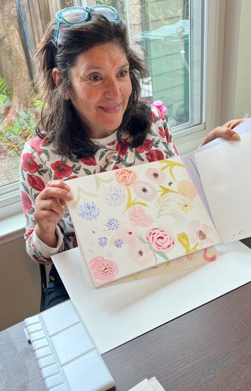 Students painting watercolor florals at a workshop in the Bay Area