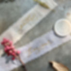 Gold hot foil calligraphy on blush satin ribbon, created using heat pen foiling technique for modern calligraphy projects