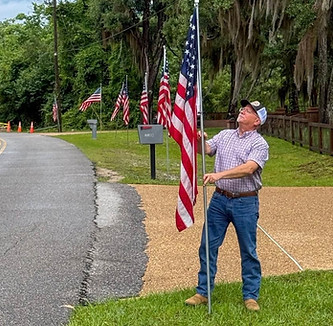 Brian McBroom putting up Memorial Day flags for Kiwanis Club.