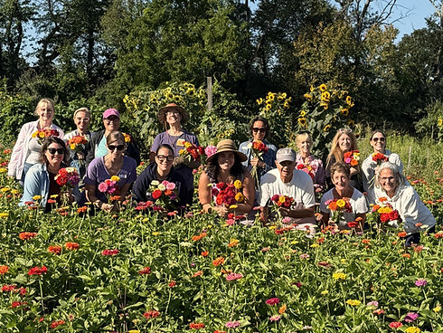 Casey and cut flowers crew in the zinnias with sunflowers edited for warmth_edited.jpg