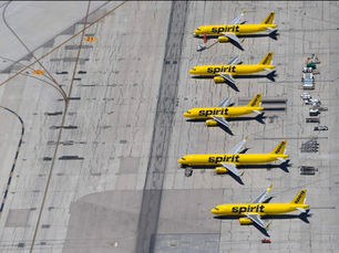 Spirit Airlines planes parked at airport gate after operations shutdown, symbolizing sudden business collapse.