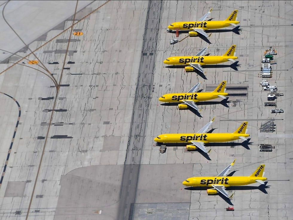 Spirit Airlines planes parked at airport gate after operations shutdown, symbolizing sudden business collapse.