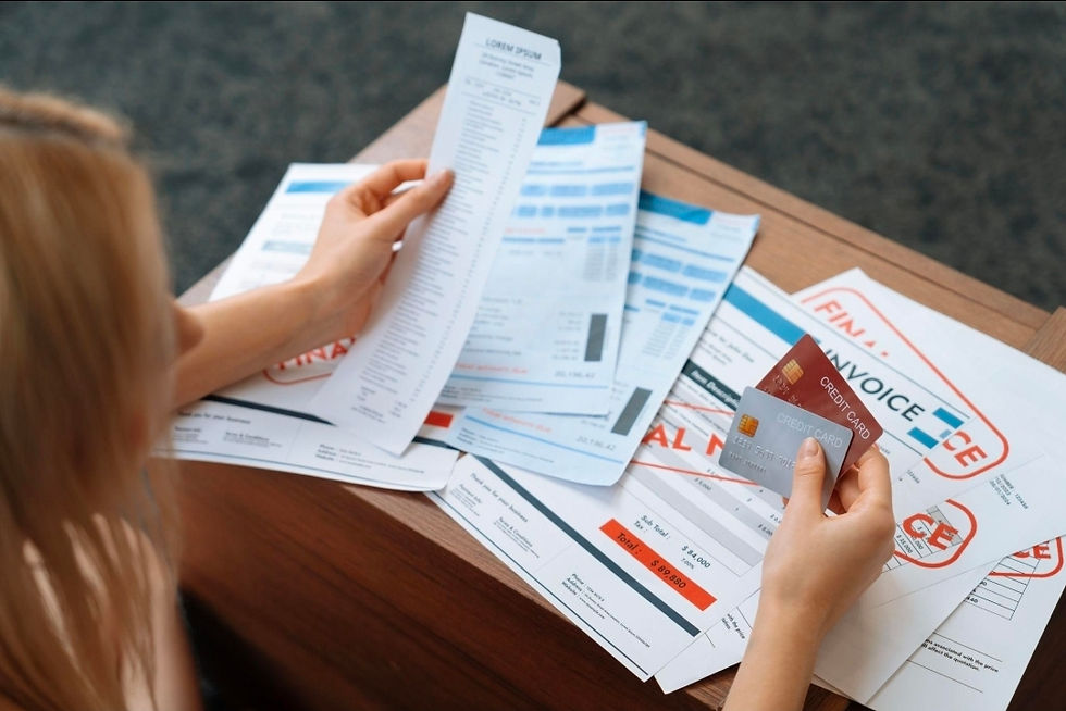 Stack of credit cards and unpaid bills on table representing financial stress and reliance on future income.