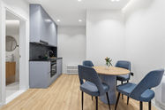 Modern kitchen and dining area with blue chairs