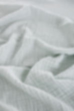 Mint colour muslin fabric closer view.