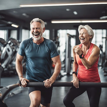 two middle-aged people at gym laughing, in the distance.jpg
