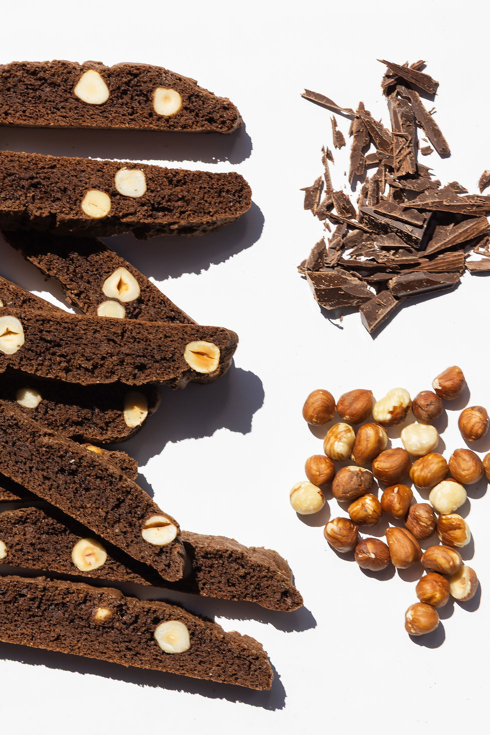 Chocolate hazelnut biscotti cookies with chocolate shavings and whole hazelnuts