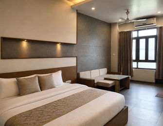 Spacious Super Classic Room with king bed and modern interiors at Hotel Rajdeep Mount Abu.