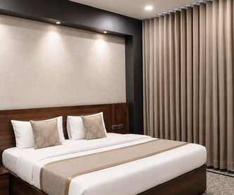 Super Deluxe Room with king bed, private balcony and modern interiors at Hotel Rajdeep Mount Abu.