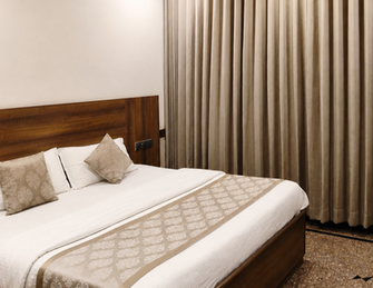Deluxe AC room with king bed and modern interiors at Hotel Rajdeep Mount Abu.