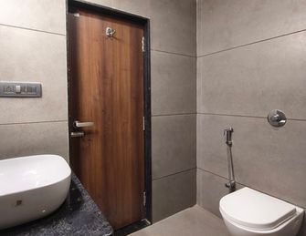 Attached bathroom with modern fittings in Deluxe Room at Hotel Rajdeep Mount Abu.