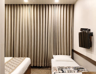 Spacious Deluxe Room designed for couples and travellers at Hotel Rajdeep Mount Abu.