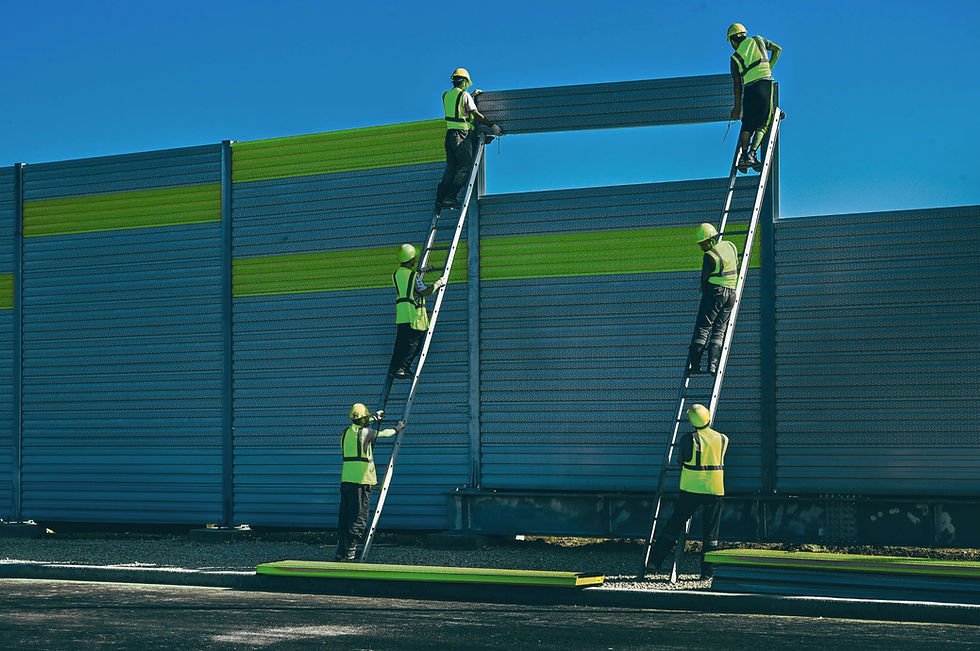 two ladders with six worker men on the ladders constructing a metal boarder / wall