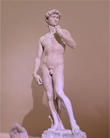 Michelangelo's David marble statue, standing with a pensive expression.