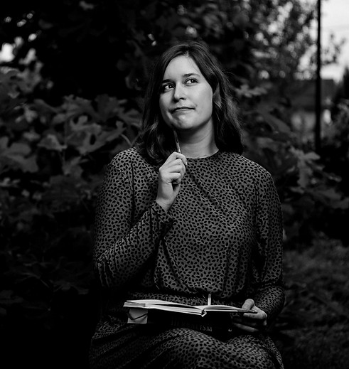 A woman sitting on a bench holding a blu